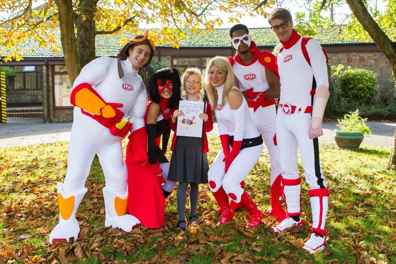 Medikidz team in superhero costumes bringing medical education to life at a school event
